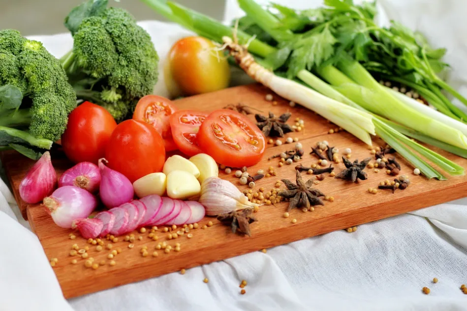 A wooden cutting board displays vegetables and spices, promoting the consumption of often overlooked foods.